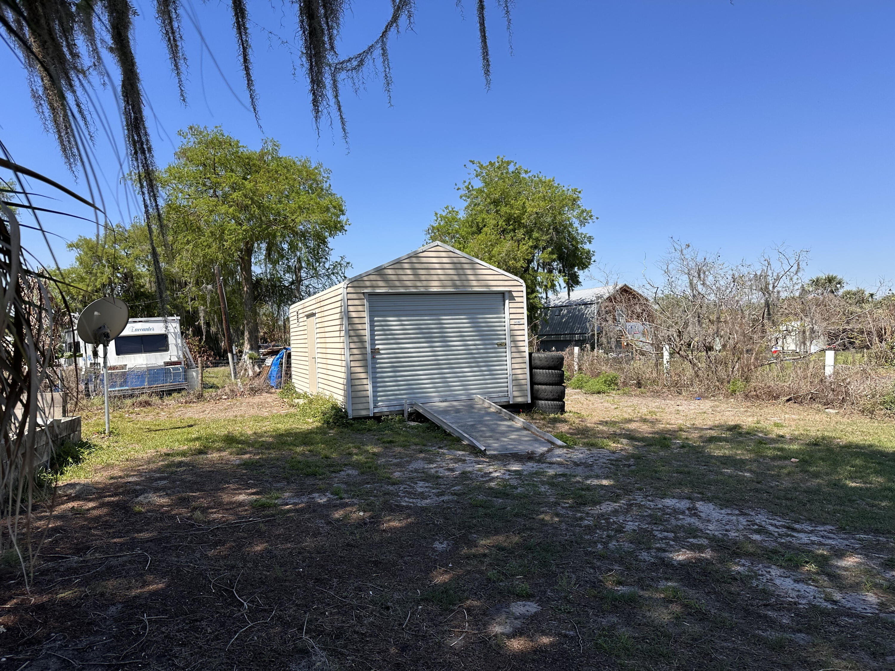 14455 Highway 78 Okeechobee, FL 34974 - Photo 12 of 14 a front view of a house with garden