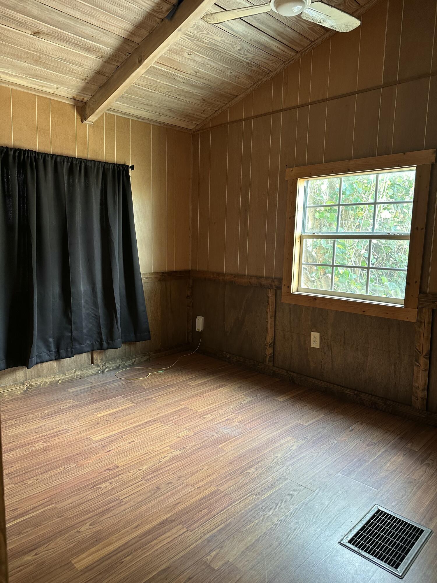 14455 Highway 78 Okeechobee, FL 34974 - Photo 5 of 14 a view of an empty room with wooden floor and a window