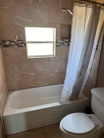 a white bath tub sitting next to a white toilet