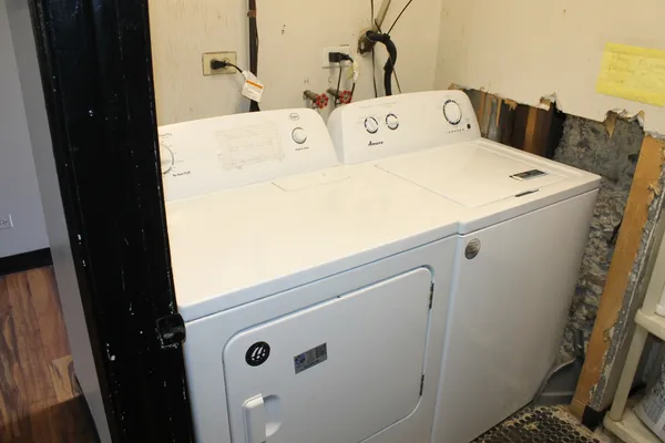 a close up of a storage and utility room with a refrigerator