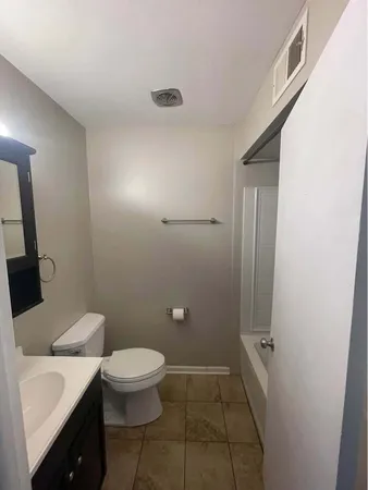 a bathroom with a toilet a sink and shower