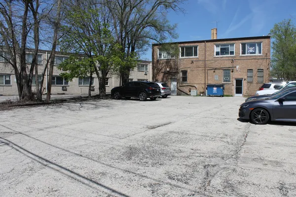 a front view of a house with cars parked