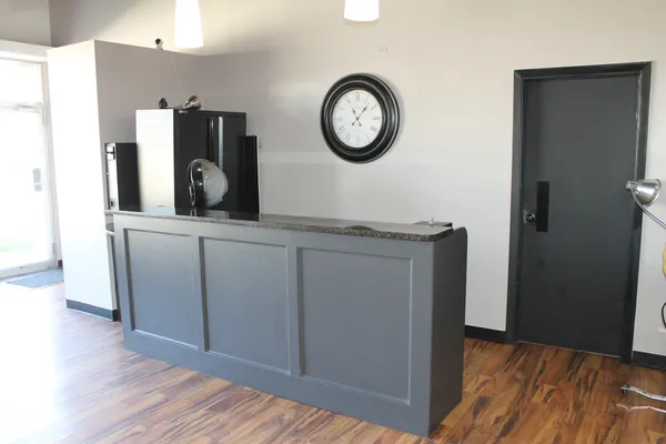 a view of a kitchen with stainless steel appliances granite countertop a refrigerator and a stove