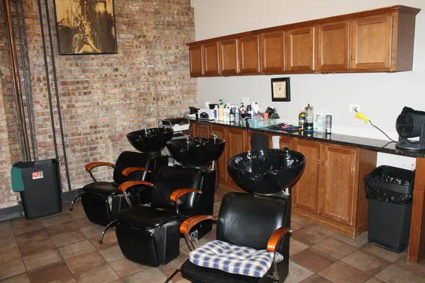 a kitchen with stainless steel appliances a stove a sink and a refrigerator
