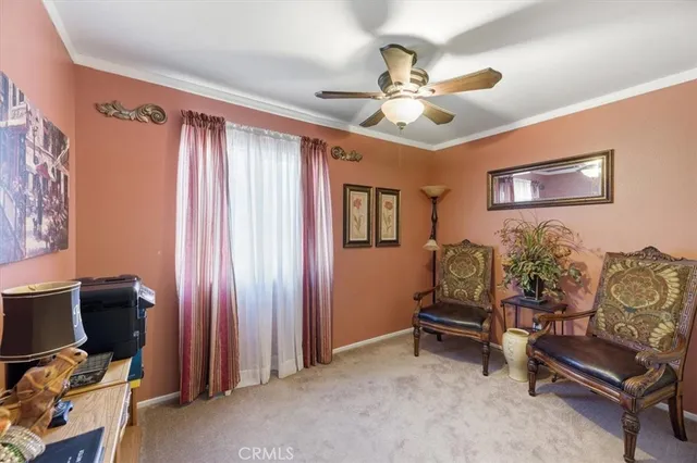 a view of a livingroom with workspace and a window