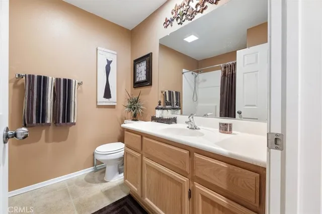 a bathroom with a sink toilet and mirror