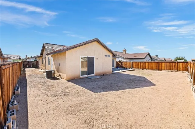 a view of a house with wooden fence