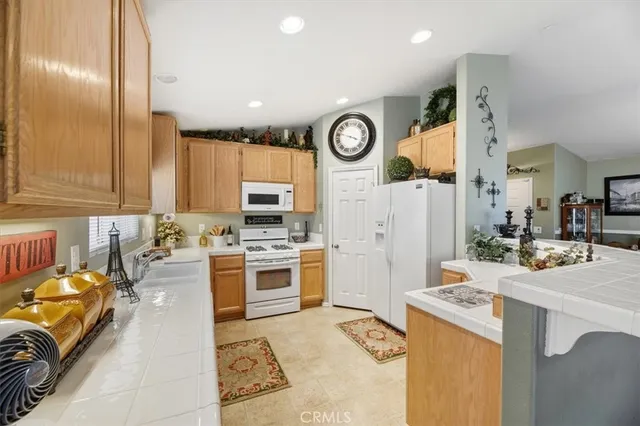 a kitchen with a refrigerator a stove top oven a sink and dishwasher