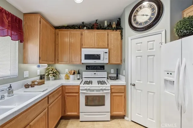 a kitchen with stainless steel appliances granite countertop a stove and a refrigerator