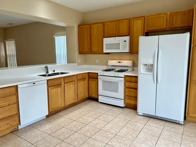 a kitchen with a stove sink and refrigerator