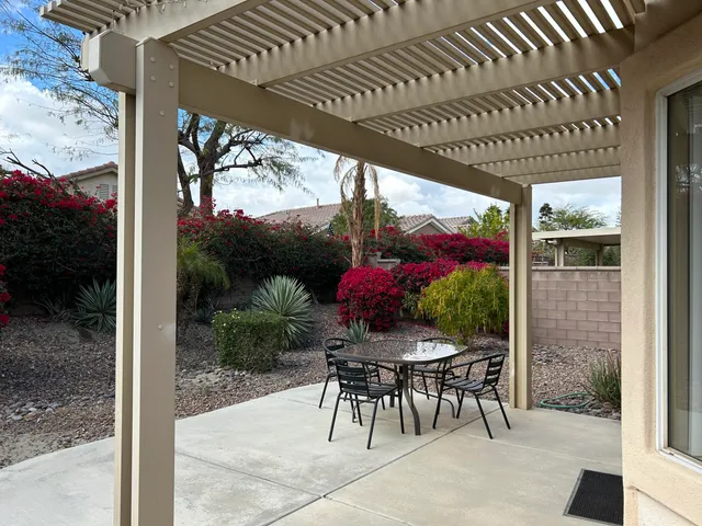 a patio with a patio table and chairs