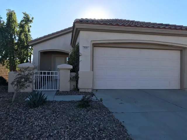 a view of a house with a small yard and plants