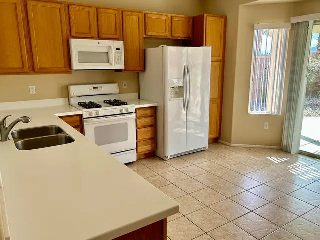 a kitchen with stainless steel appliances a refrigerator sink and cabinets