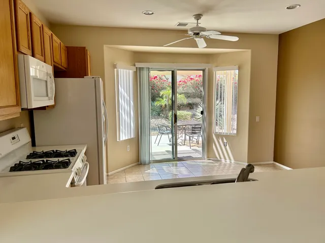 a view of kitchen with windows and refrigerator