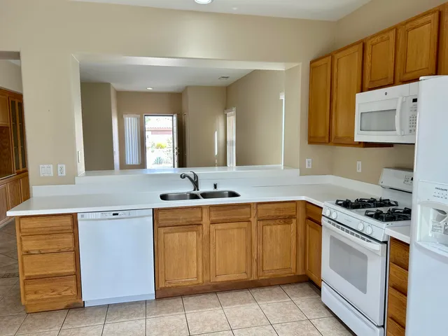 a kitchen with a stove sink and cabinets