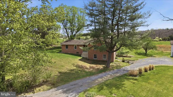 a balcony with wooden floor table and chairs