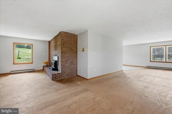 a view of a house with a yard and large tree
