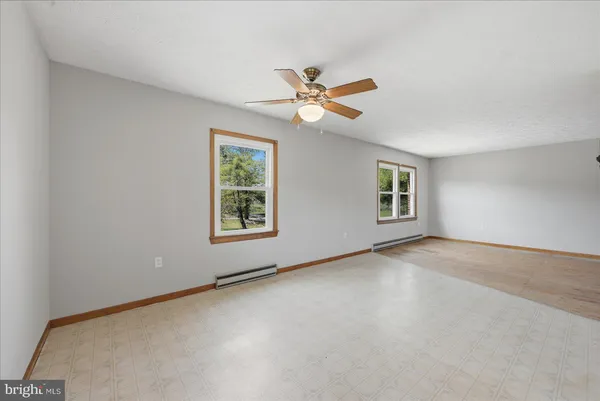 a view of backyard with cabin and wooden fence