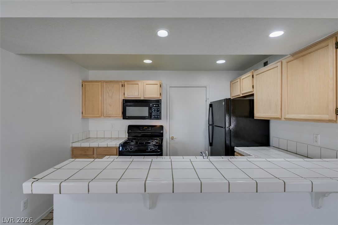 7570 West Flamingo Road, Unit 252 Las Vegas, NV 89147 - Photo 21 of 44 Functional kitchen with ample counter space and appliances, ready for culinary endeavors.