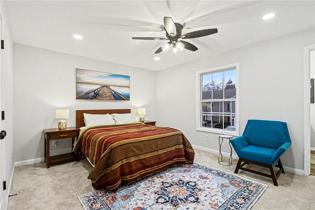616 Summer Place Northwest Norcross, GA 30071 - Photo 13 of 24 a bedroom with a bed a couch and a window