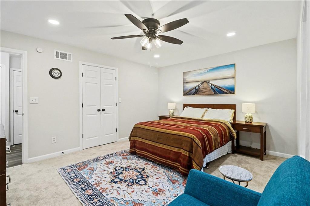 616 Summer Place Northwest Norcross, GA 30071 - Photo 14 of 24 a bedroom with a bed and a dresser with mirror