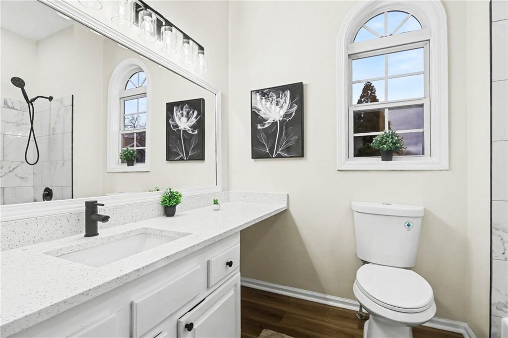 616 Summer Place Northwest Norcross, GA 30071 - Photo 17 of 24 a bathroom with a granite countertop toilet sink and mirror