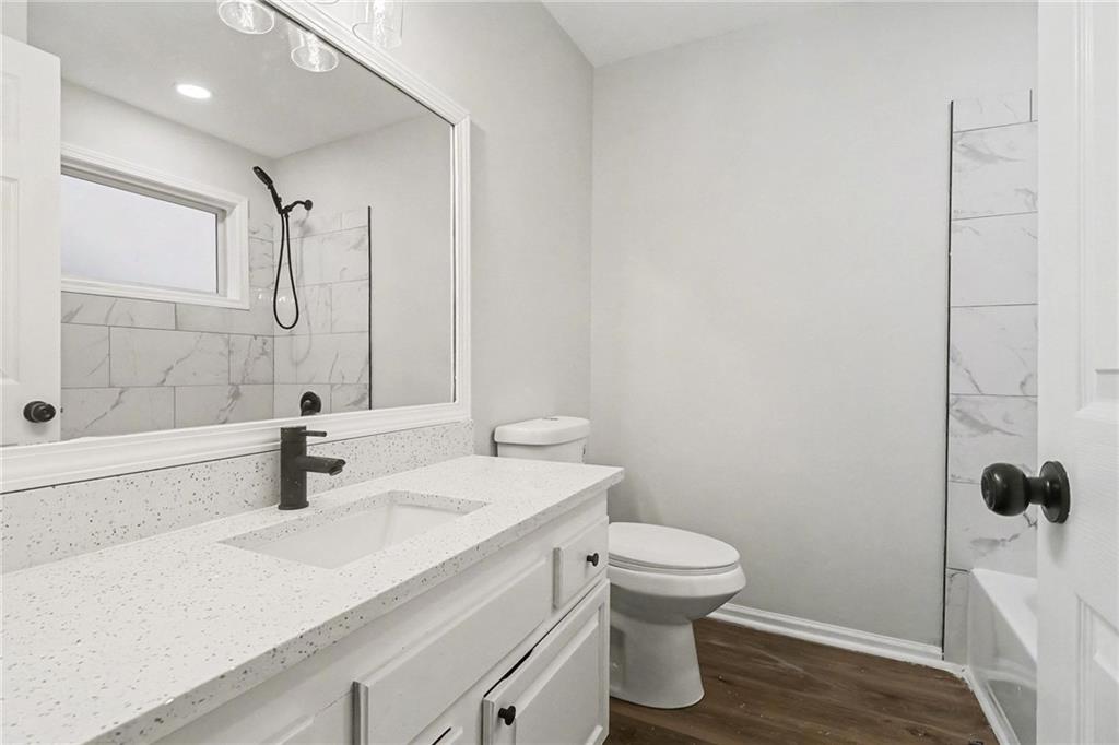 616 Summer Place Northwest Norcross, GA 30071 - Photo 21 of 24 a bathroom with a sink a toilet and shower