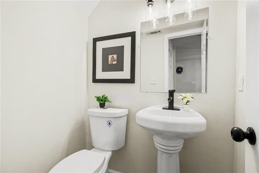 616 Summer Place Northwest Norcross, GA 30071 - Photo 22 of 24 a bathroom with a toilet sink and mirror