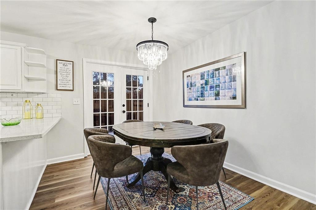 616 Summer Place Northwest Norcross, GA 30071 - Photo 7 of 24 a dining room with furniture a rug and wooden floor