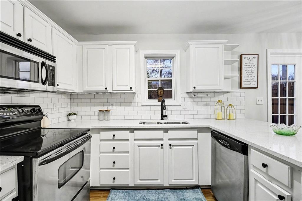616 Summer Place Northwest Norcross, GA 30071 - Photo 10 of 24 a kitchen with stainless steel appliances granite countertop a sink stove and cabinets