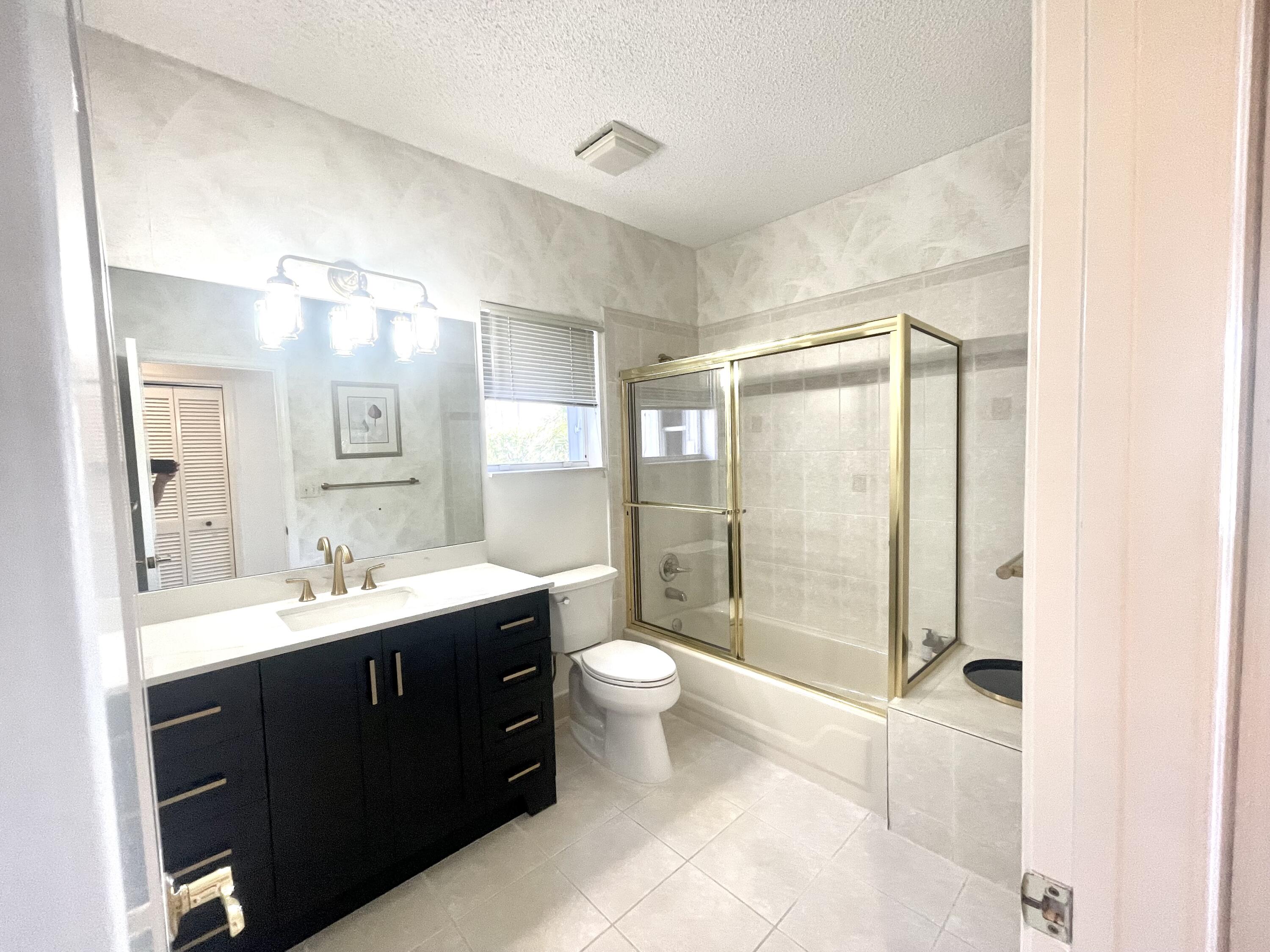 2033 Staysail Lane Jupiter, FL 33477 - Photo 11 of 40 a bathroom with a double vanity sink toilet and shower