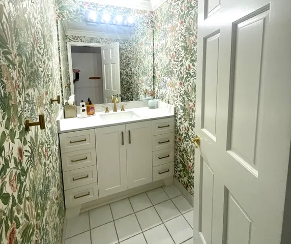 a bathroom with a sink a vanity and a mirror