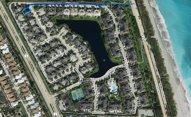 a front view of a house with a yard and potted plants