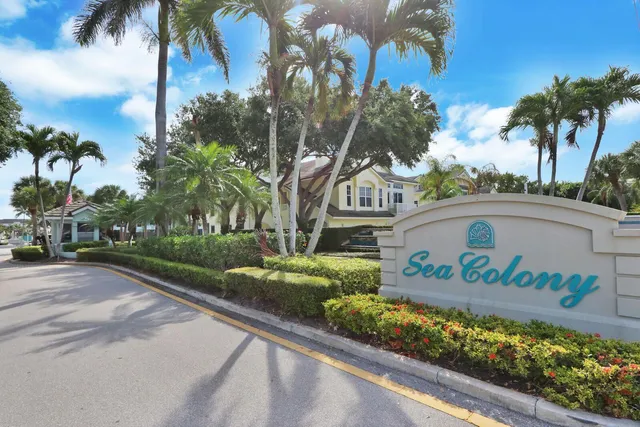 a view of a swimming pool with lawn chairs and a yard