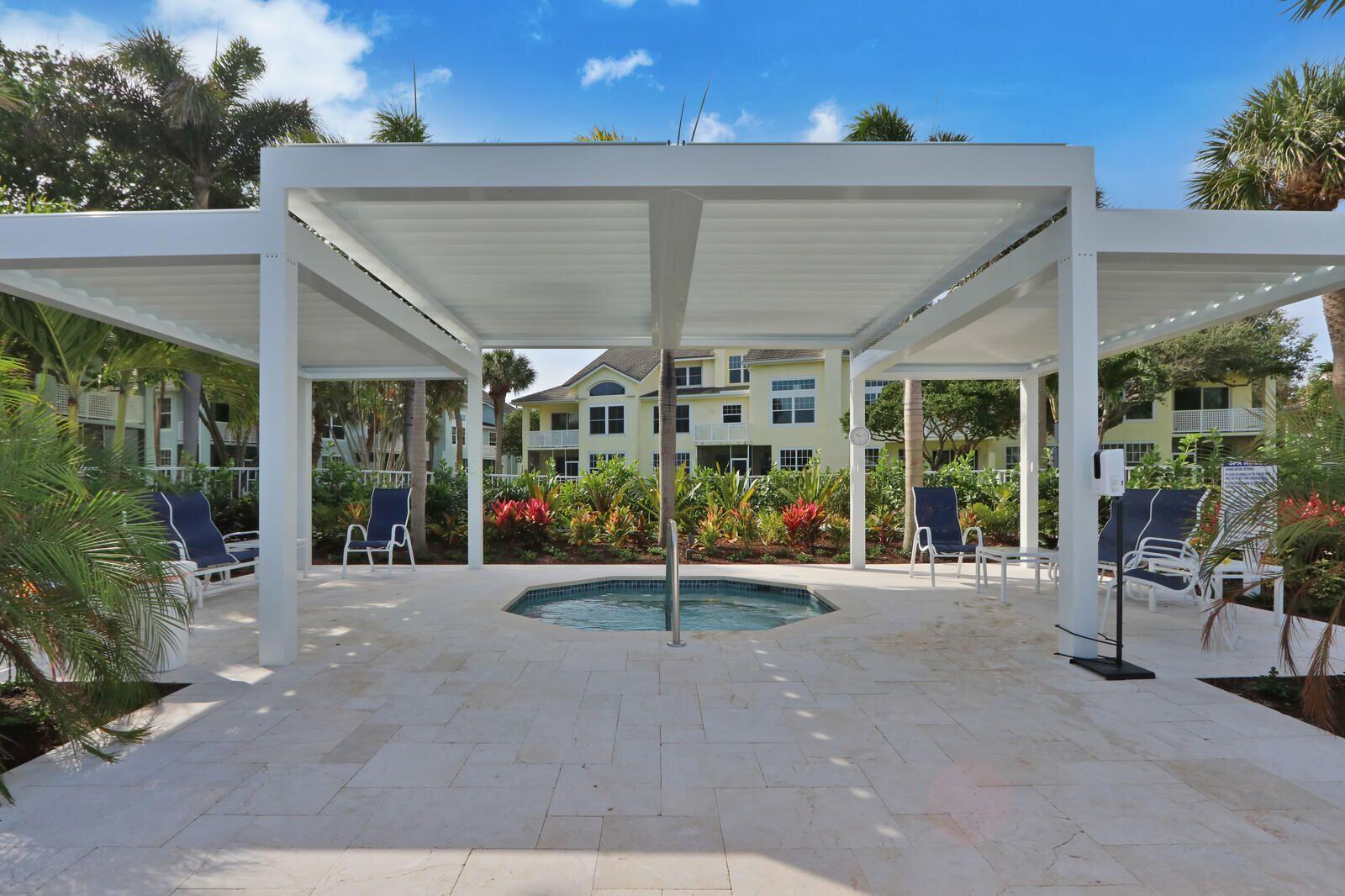 2033 Staysail Lane Jupiter, FL 33477 - Photo 20 of 40 a view of a patio with table and chairs and potted plants