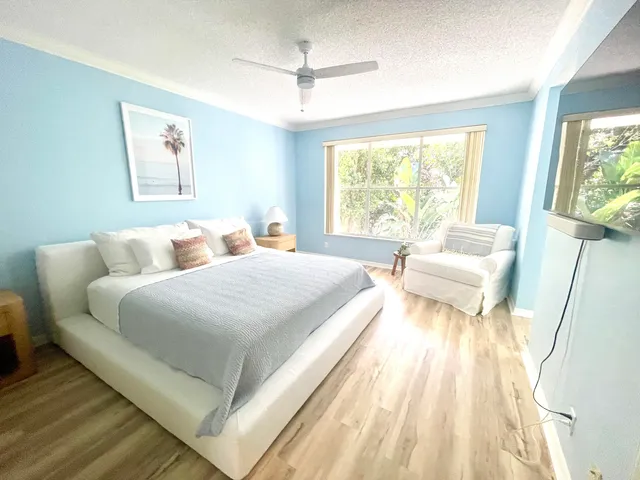 a spacious bedroom with a bed and a large window