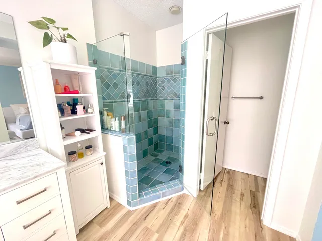 a bathroom with a shower and a sink