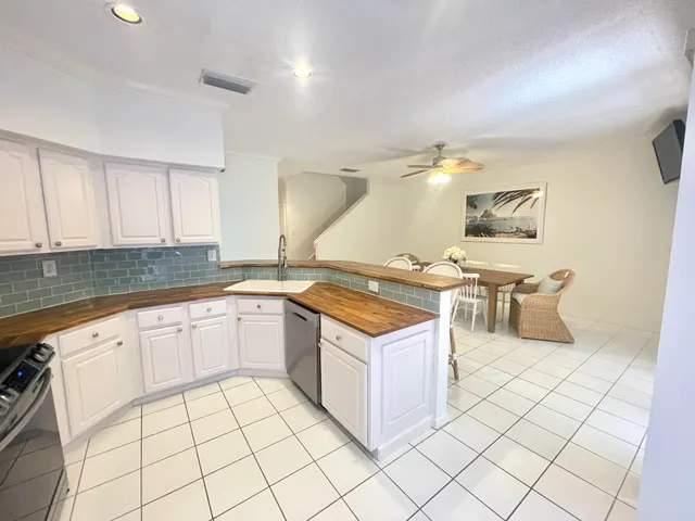 a kitchen with stainless steel appliances a stove a sink and cabinets