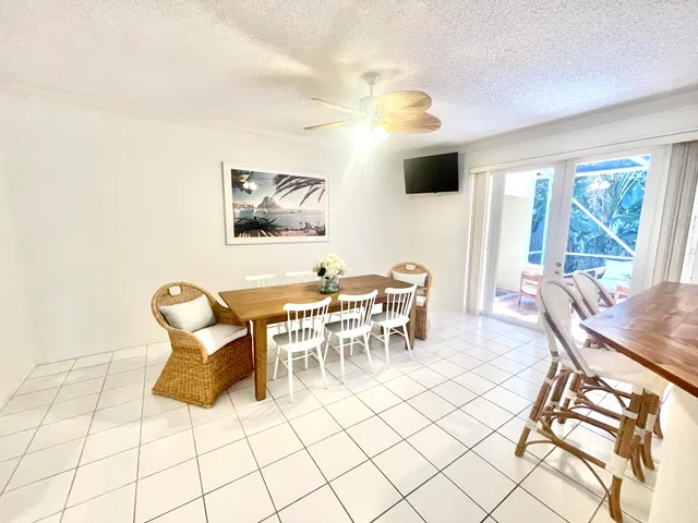 a dining room with furniture and a flat screen tv