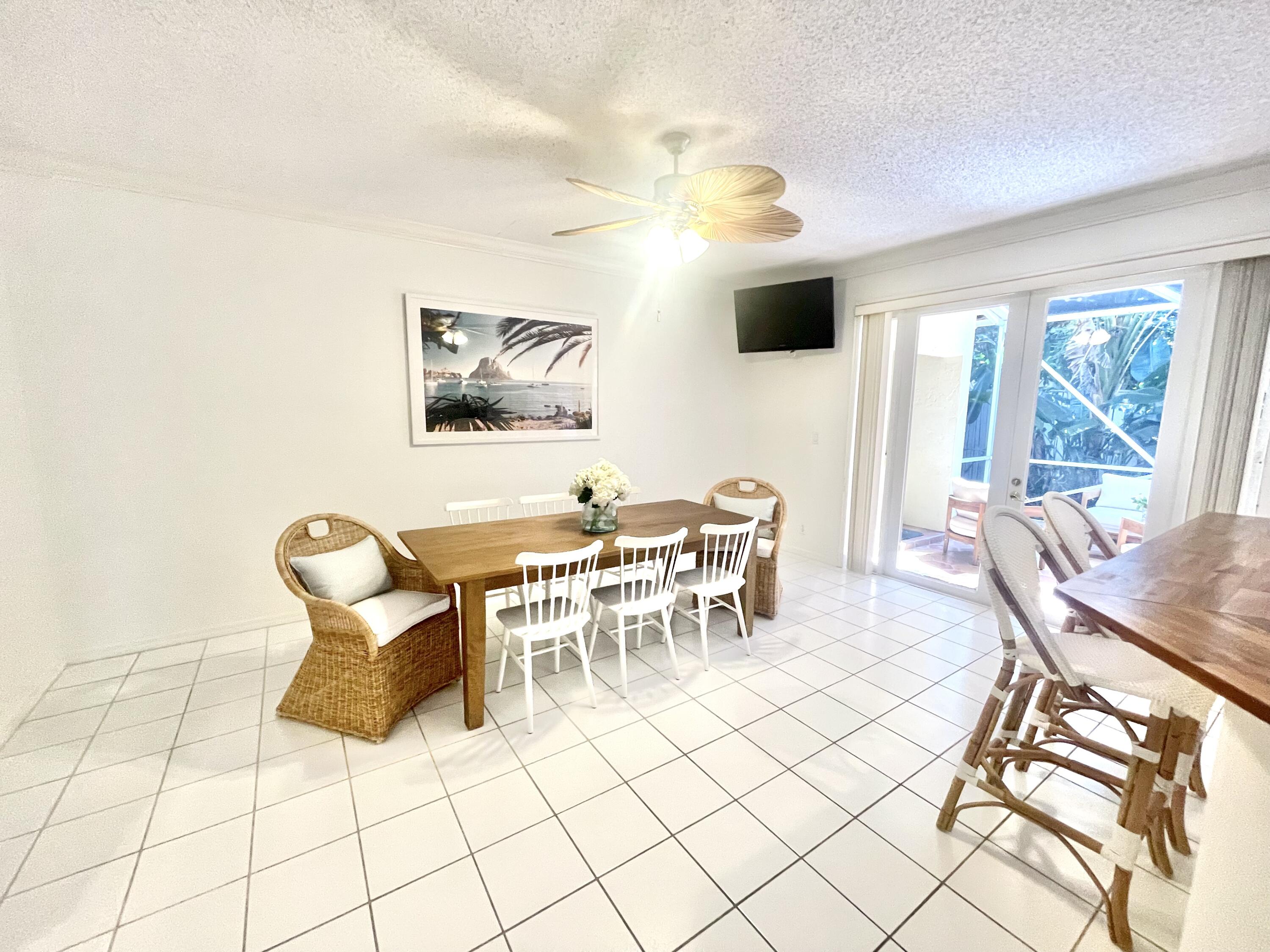 2033 Staysail Lane Jupiter, FL 33477 - Photo 8 of 40 a dining room with furniture and a flat screen tv