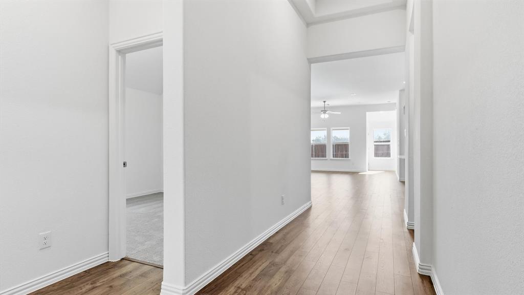 2529 Rivers W Road Anna, TX 75409 - Photo 9 of 40 Entryway featuring wood-finish flooring, white baseboards, and neutral wall tones