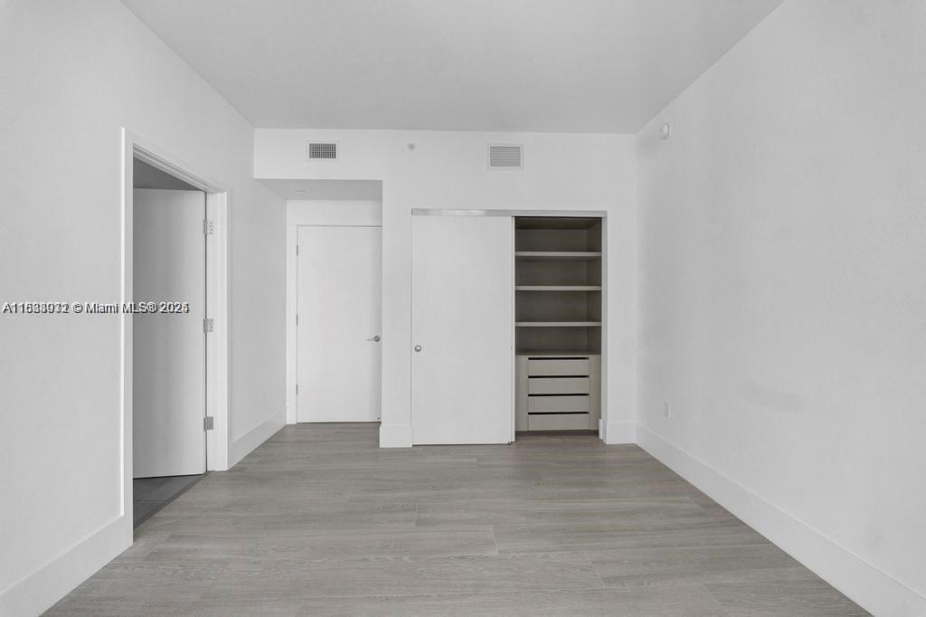 788 Northeast 23rd Street, Unit 1402 Miami, FL 33137 - Photo 16 of 42 a view of walk in closet with stairs