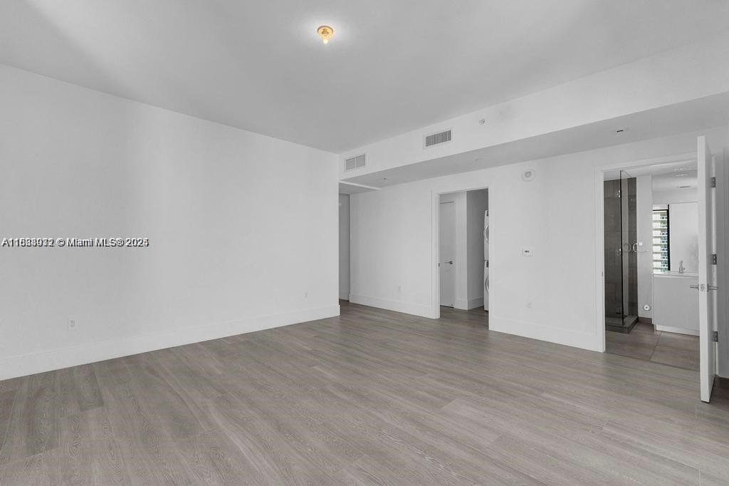 788 Northeast 23rd Street, Unit 1402 Miami, FL 33137 - Photo 19 of 42 a view of an empty room with wooden floor