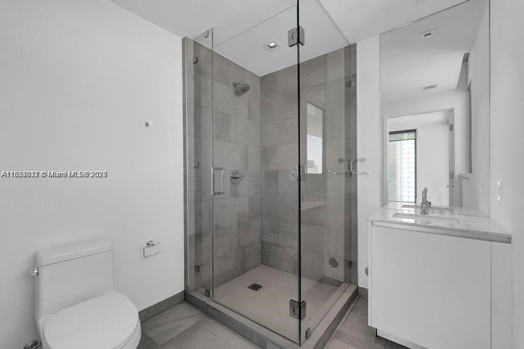 788 Northeast 23rd Street, Unit 1402 Miami, FL 33137 - Photo 20 of 42 a bathroom with a shower a toilet and a sink