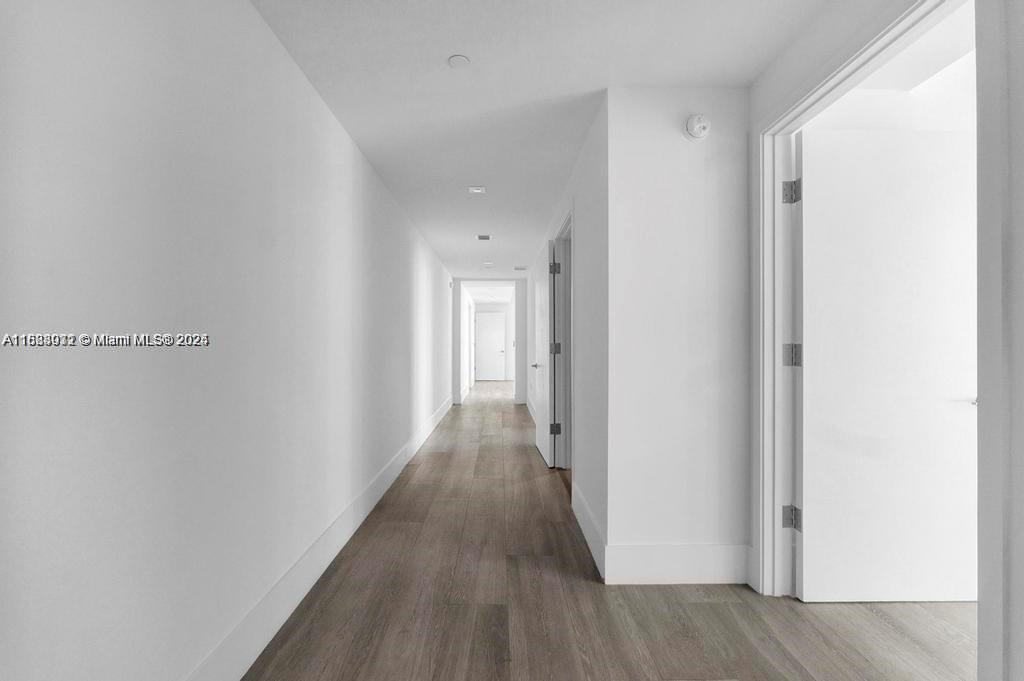 788 Northeast 23rd Street, Unit 1402 Miami, FL 33137 - Photo 21 of 42 a view of a hallway with wooden floor