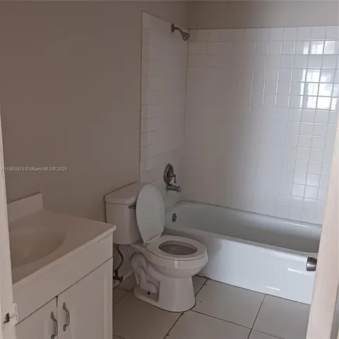 a white toilet sitting next to a bath tub