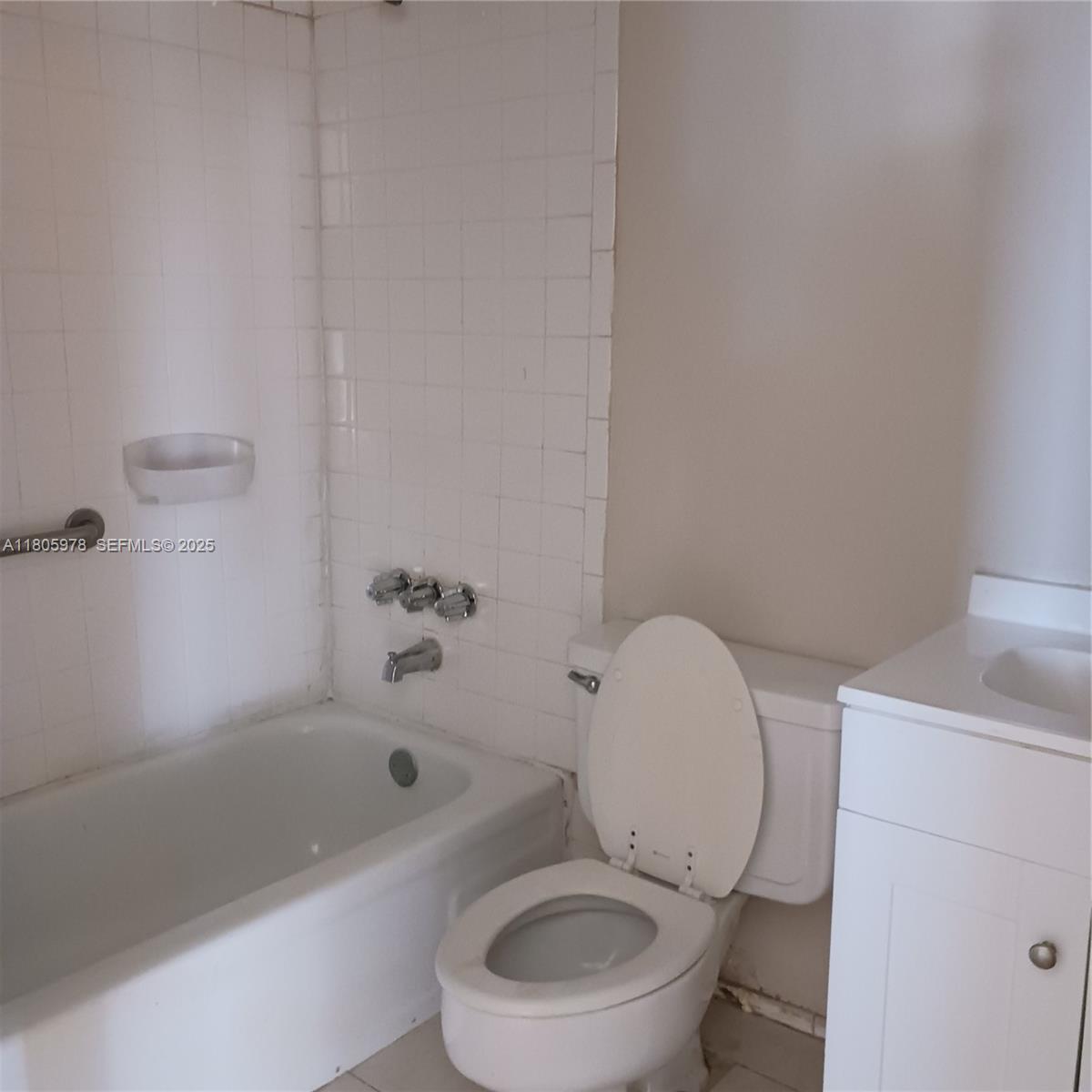 5906 Northwest 21st Street, Unit 46E Lauderhill, FL 33313 - Photo 9 of 9 a white toilet sitting next to a bath tub