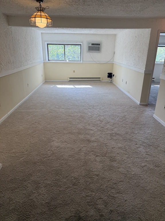310 Codman Hill Road, Unit 34D Boxborough, MA 01719 - Photo 7 of 17 a view of empty room with window and fireplace