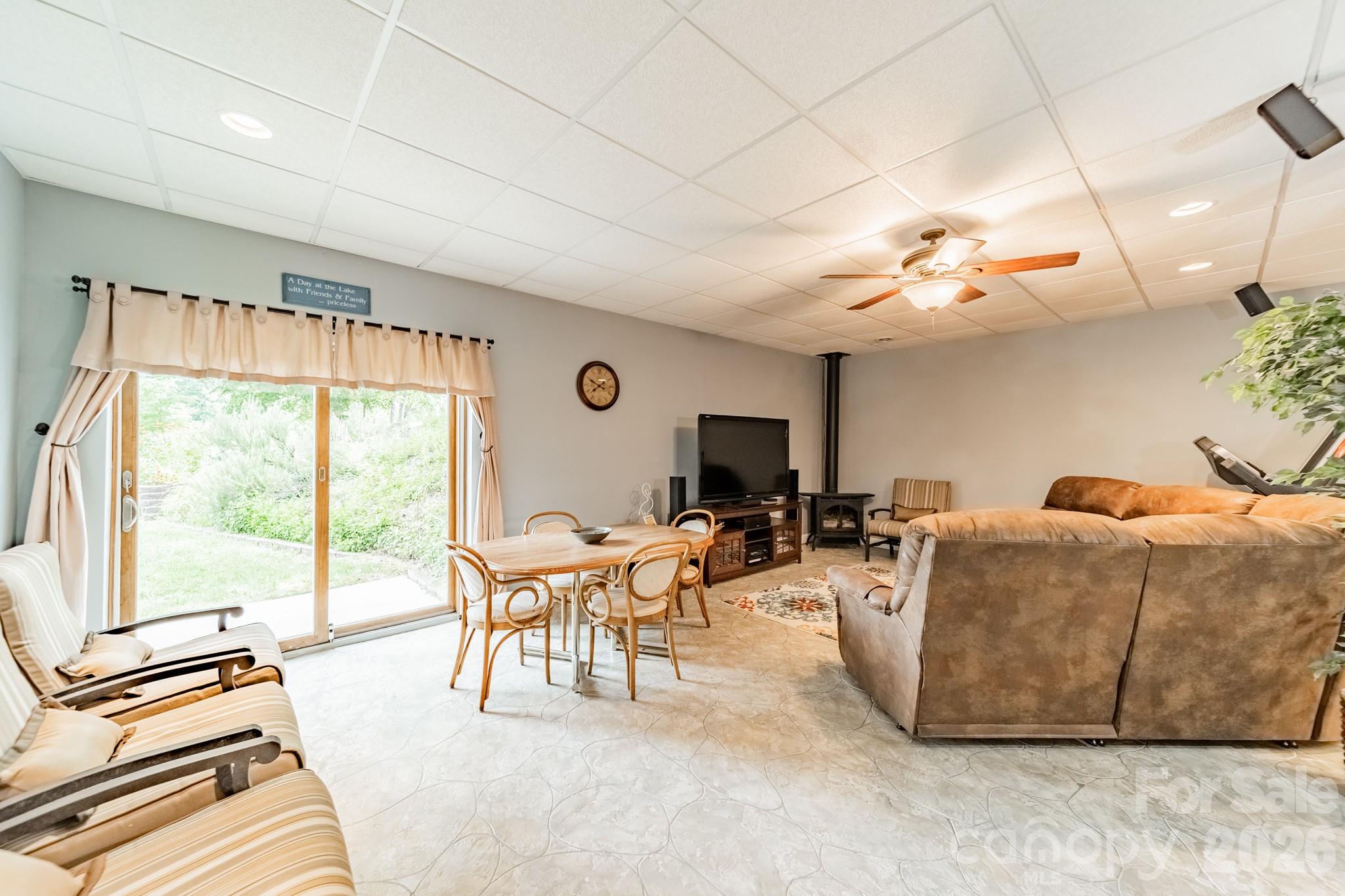 7545 Rabbit Circle Denver, NC 28037 - Photo 19 of 37 a living room with furniture a flat screen tv and a large window
