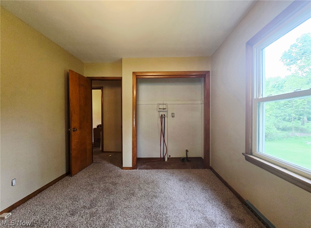 4882 Mogadore Road Kent, OH 44240 - Photo 11 of 16 Room with neutral wall paint, light-colored carpeting, a single window, and a built-in closet area with utility hookups
